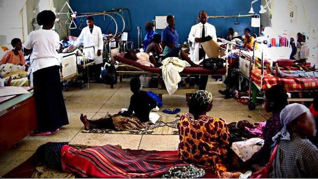 An overcrowded hospital ward with limited space and resources